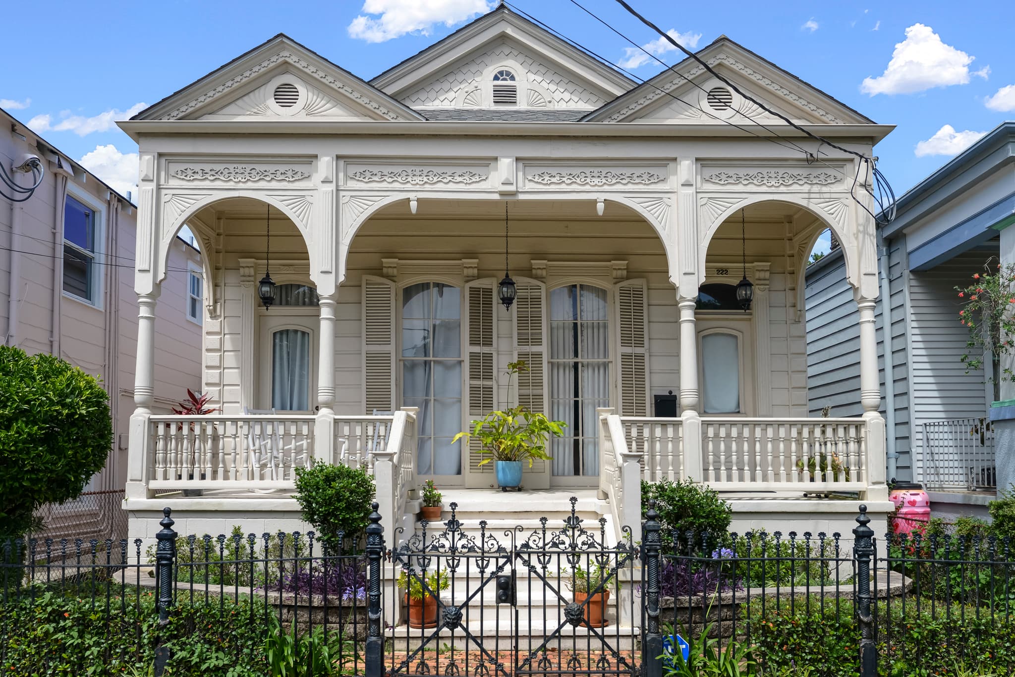 A classic New Orleans shotgun home with an ornate front porch